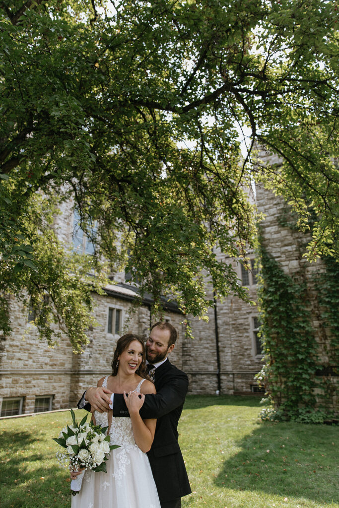 groom kissing the bride on the cheek