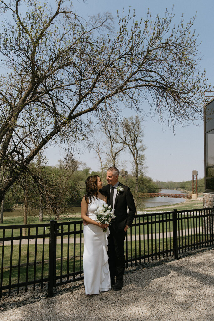 groom kissing the bride on the cheek