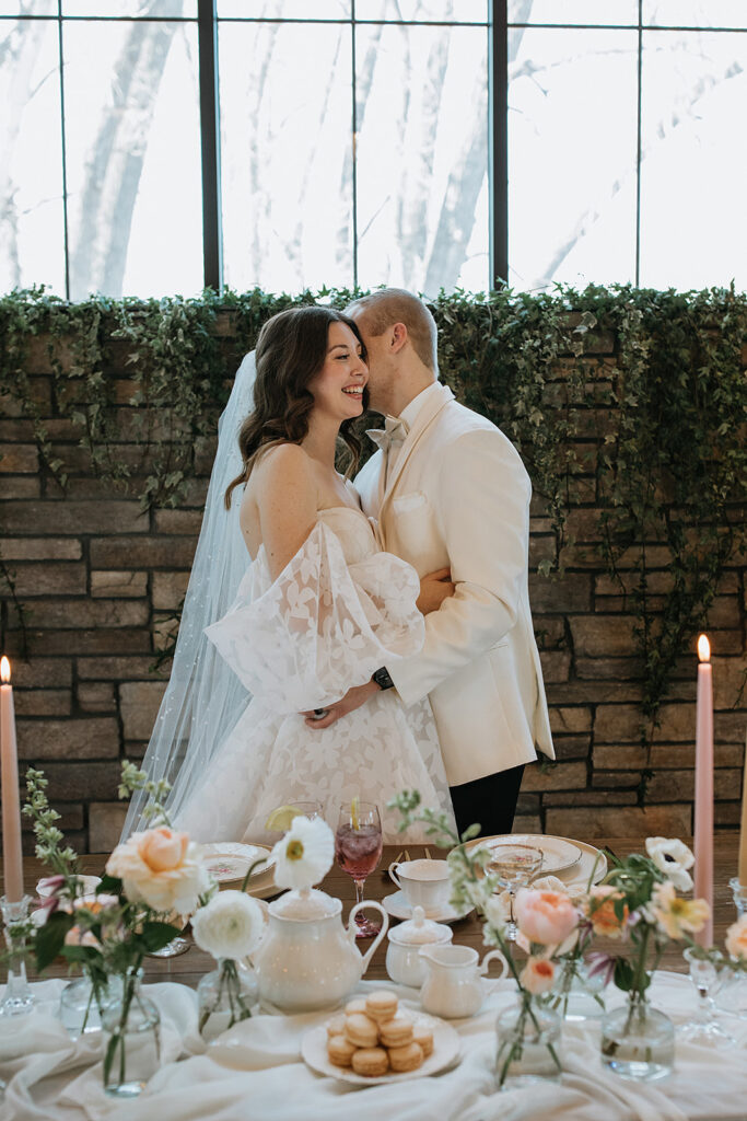 groom kissing the bride on the cheek