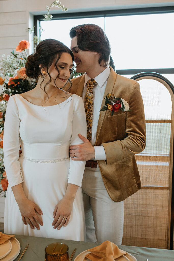 groom kissing the bride on the forehead