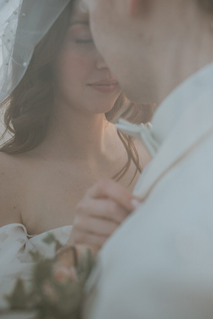 portrait of the newlyweds kissing