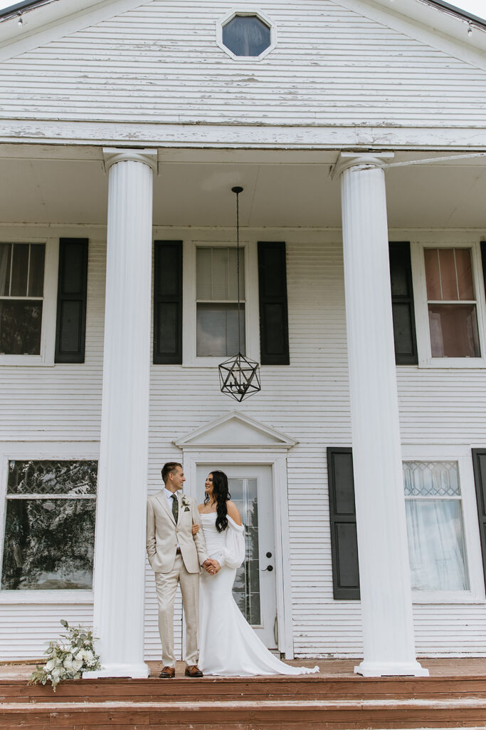 portrait of the bride and groom smiling at each other