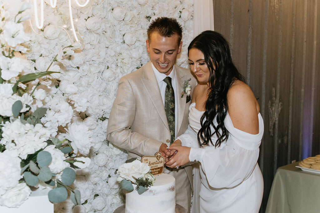 newlyweds trying their wedding cake