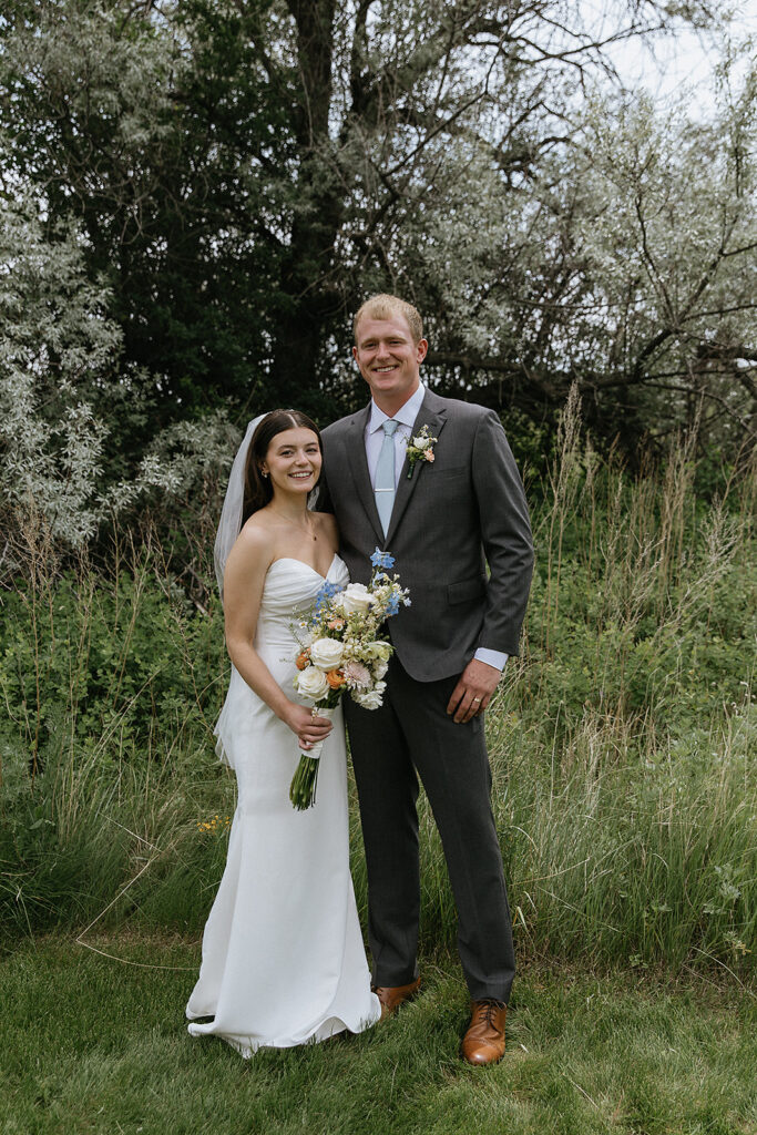 bride and groom posing for the camera during their photoshoot