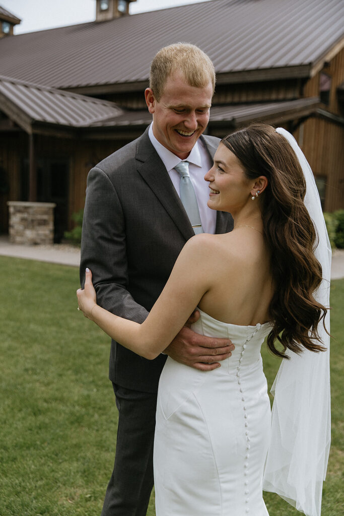 newlyweds laughing with each other during their photoshoot 