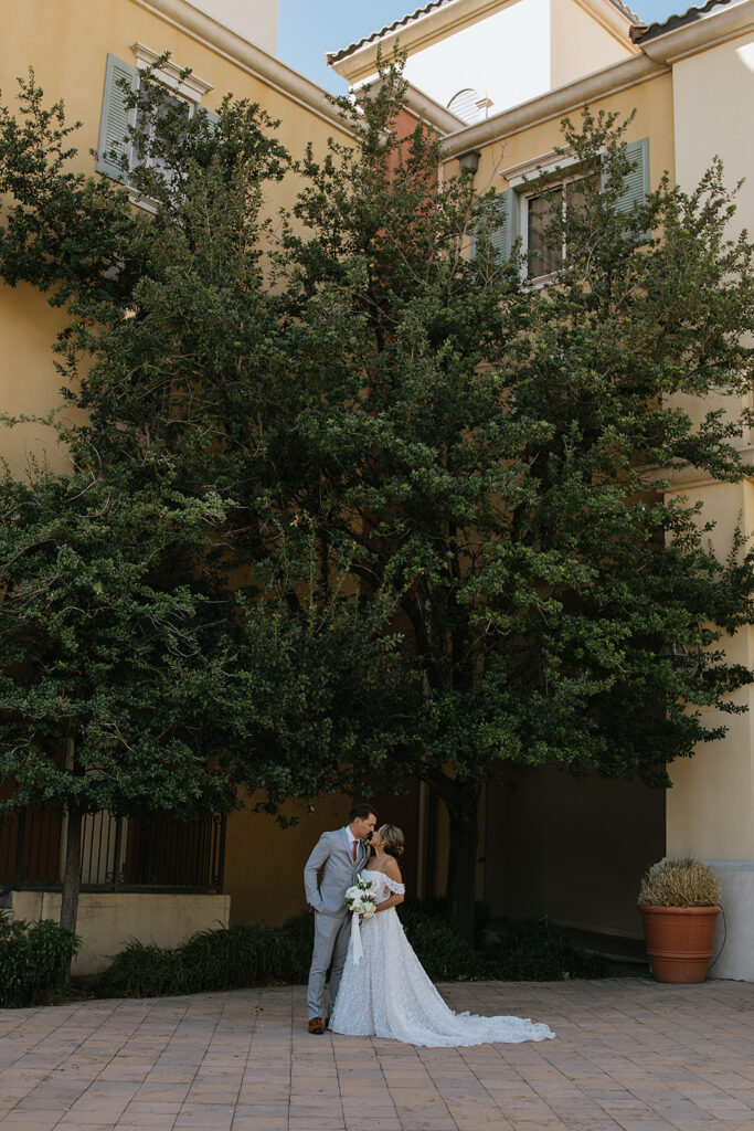 portrait of the bride and groom kissing 