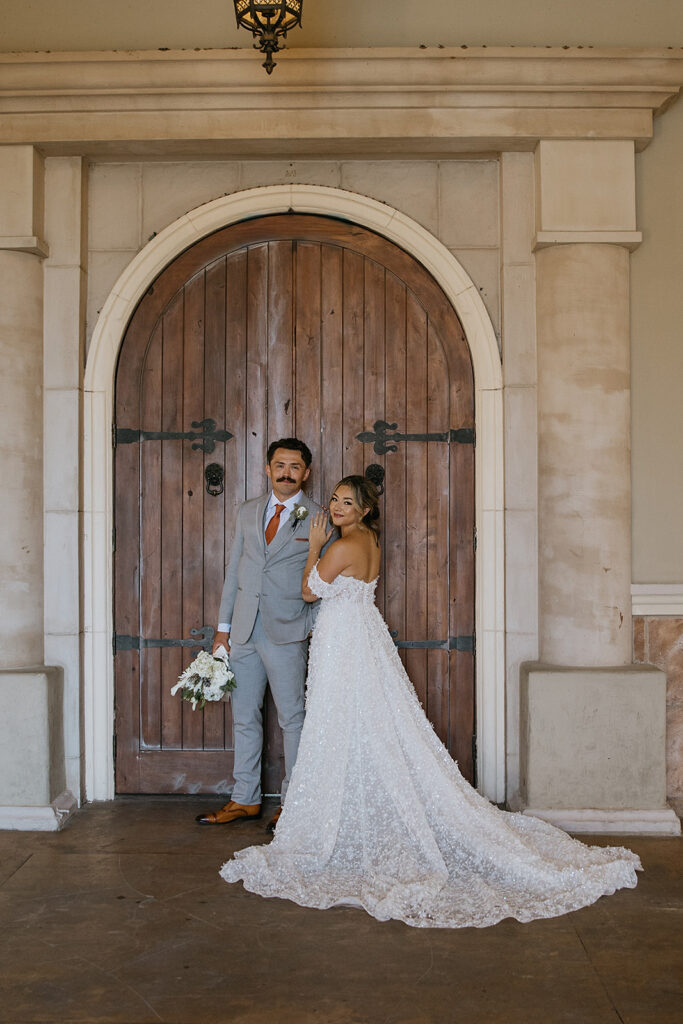 bride and groom posing for the camera during their bridal portraits