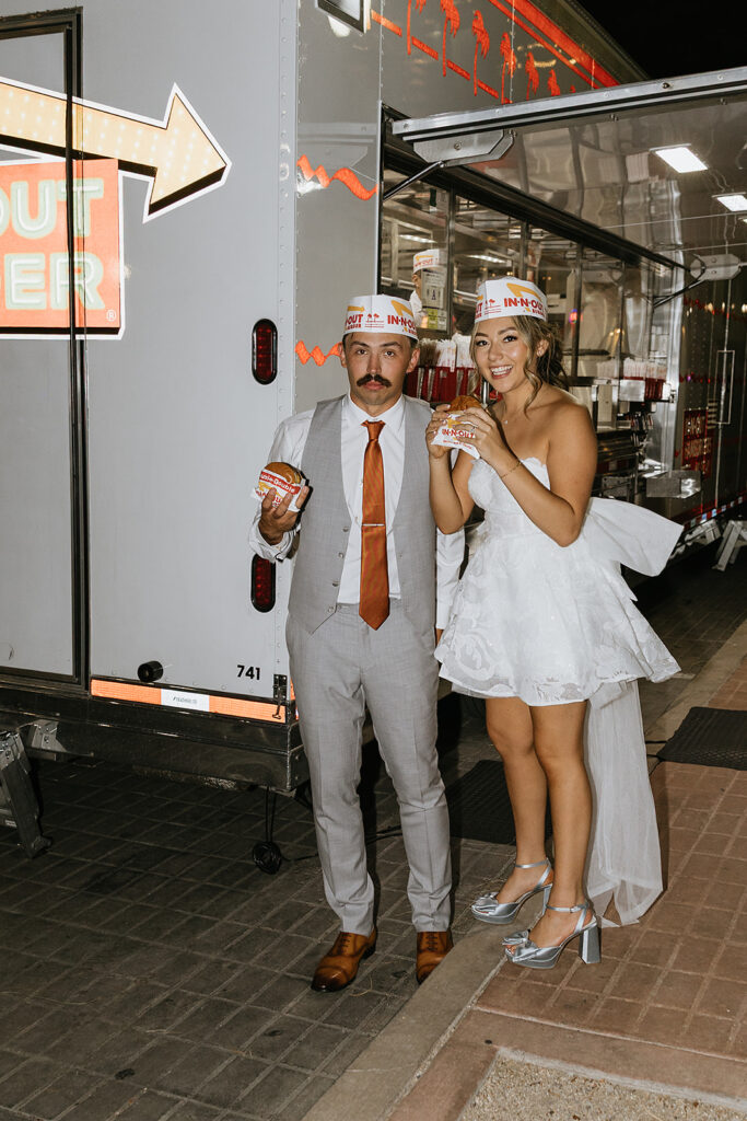 fun portrait of the newlyweds eating in n out