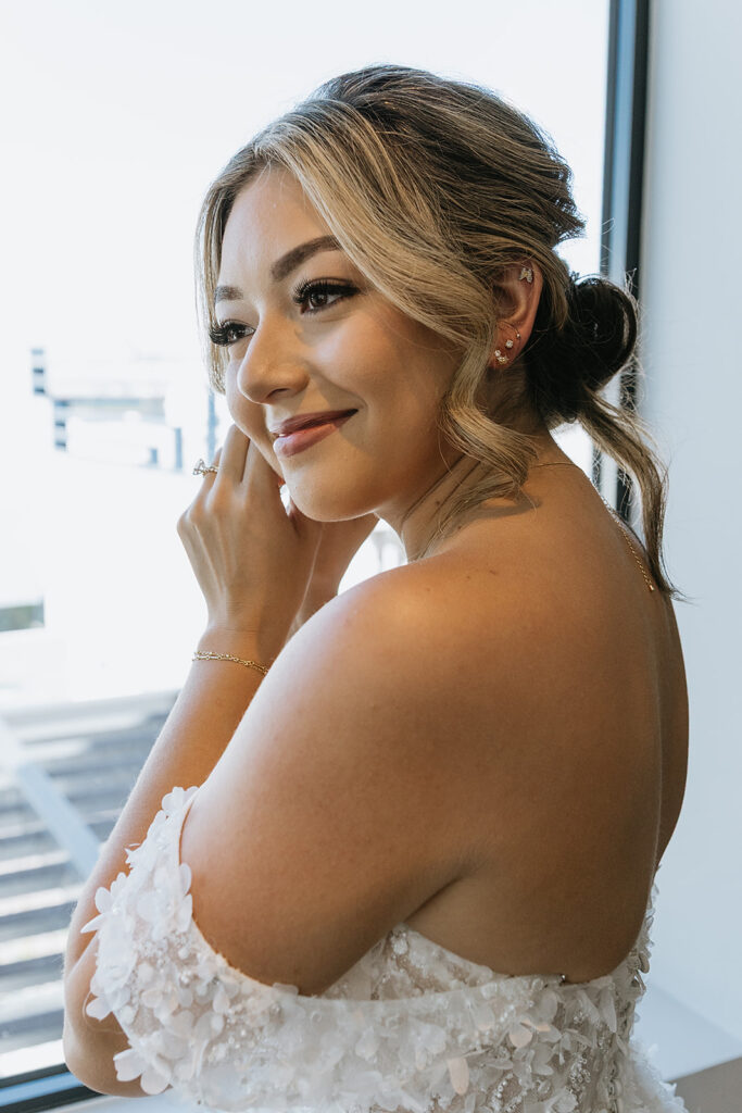 bride putting on her jewelry before her dream ceremony