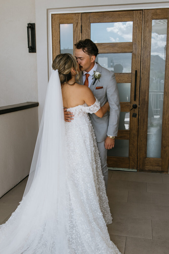 bride and groom kissing after their first look