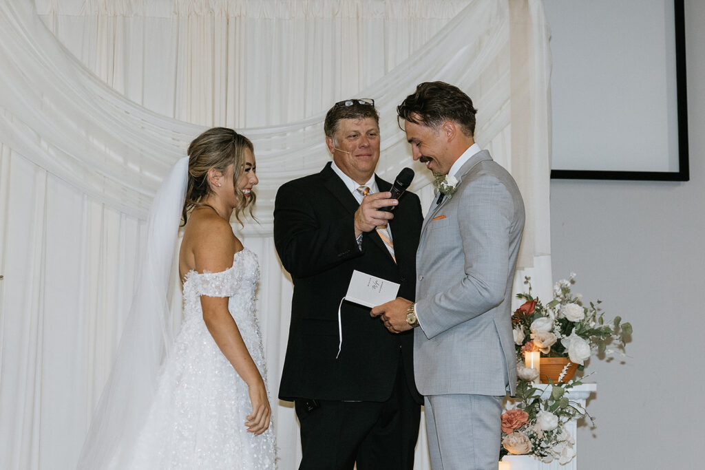 bride and groom holding hands during their ceremony