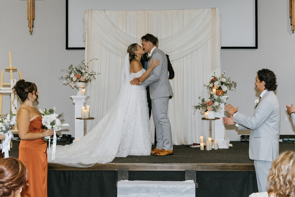 bride and groom kissing after their ceremony 