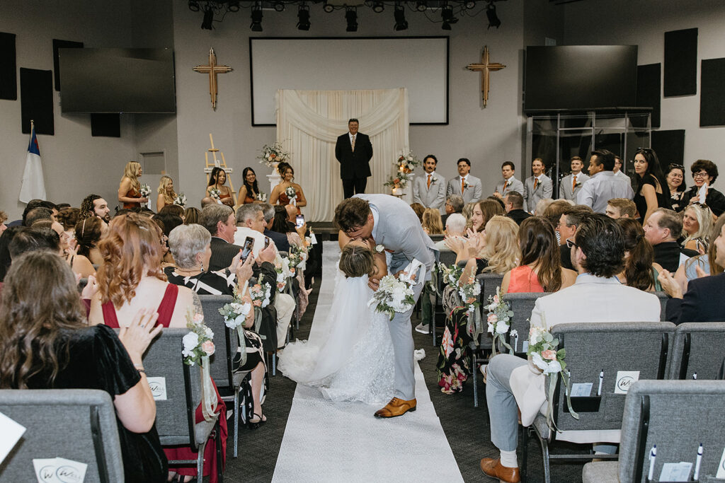 cute picture of the newlyweds kissing after their ceremony