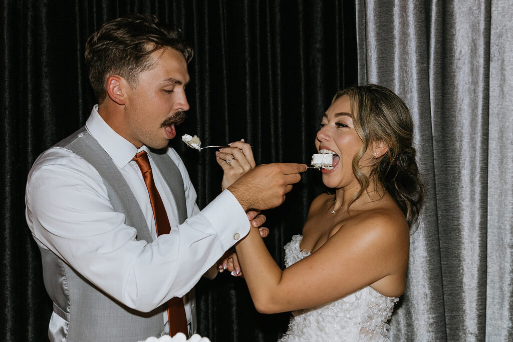 cute picture of the newlyweds trying their wedding cake