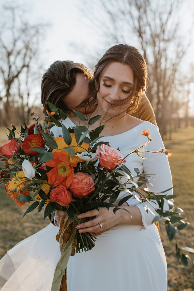 groom kissing the bride on the cheek