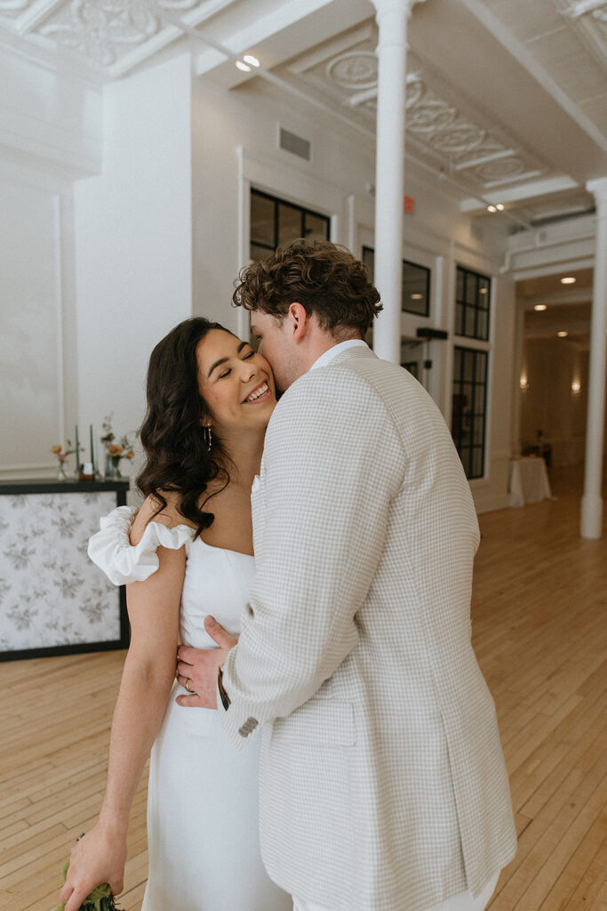 groom kissing the bride on the cheek